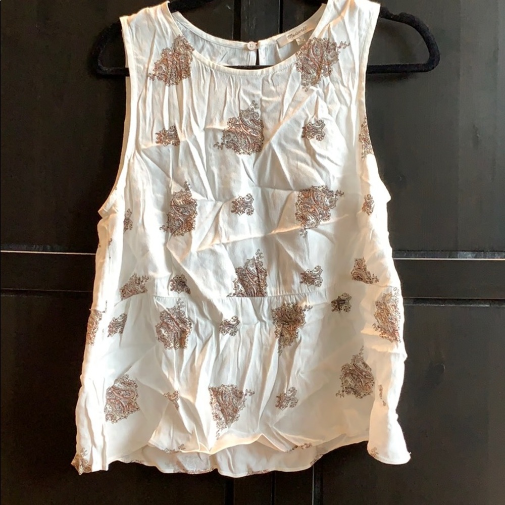 White sleeveless peplum blouse.
